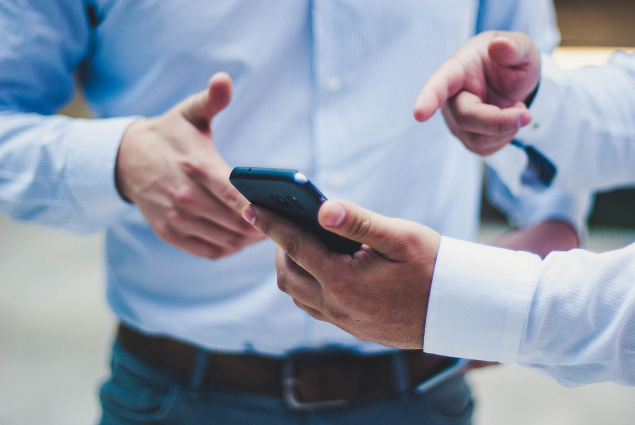 Two men with a cell phone