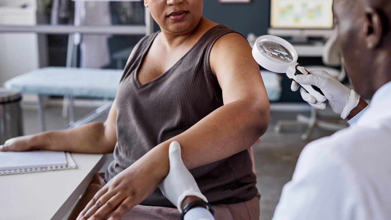 Dermatologist attending to a patient