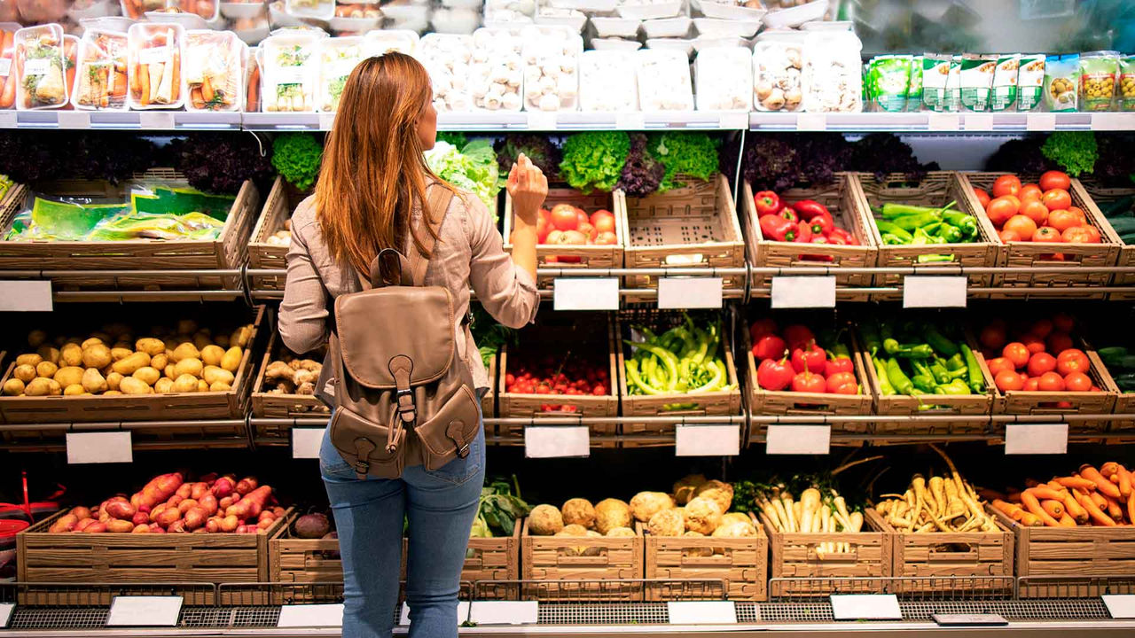 woman in a supermarket looking at vegetables