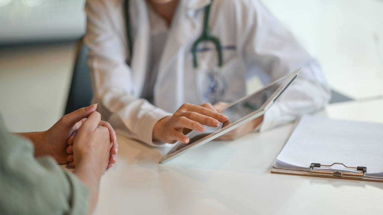 Shot of a doctor showing a patient some information on a digital tablet Shot of a doctor showing a patient some information on a digital tablet